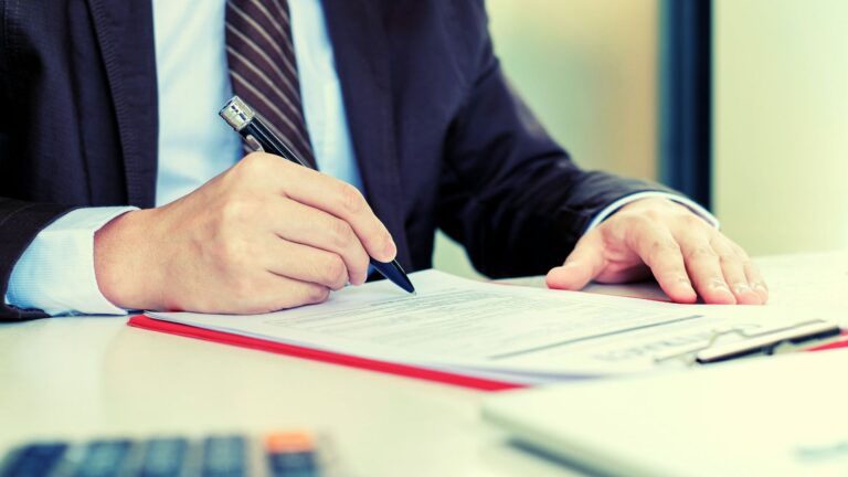 Man in suit filling out a survey