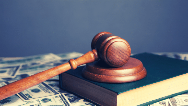 judge's gavel over a pile of money