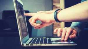 Two people using a laptop